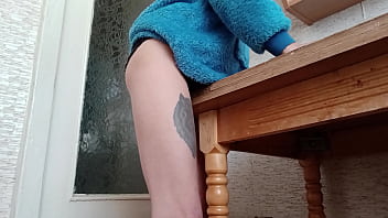 Skinny brunette rubs her pussy on the table in the