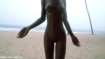 Skinny ebony village girl dancing naked in the rain with