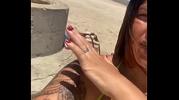 Married woman attracting attention on the beach with a stiletto