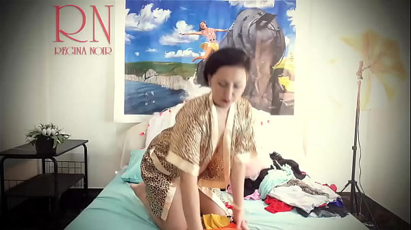 Housewife laid out sexy lingerie and outfits on the bed.