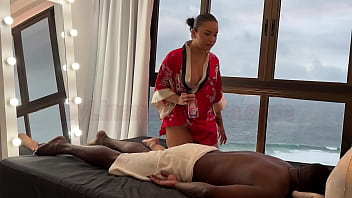 Asian masseuse gives a relaxing massage to a gifted black