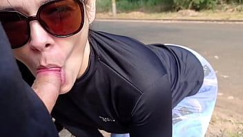 MILF sucking young man's dick in the middle of the