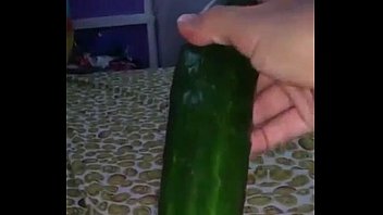 Masturbating with cucumber.