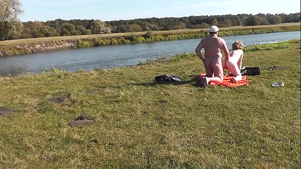 Wild beach. Nudist beach. Outdoors on bank of river lover