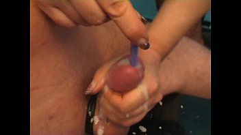Mistress inserting toothrbush in a guy's cock while she jerks