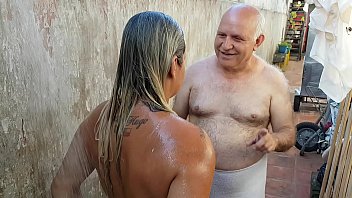 Grandpa bathing the young girl he met on the beach